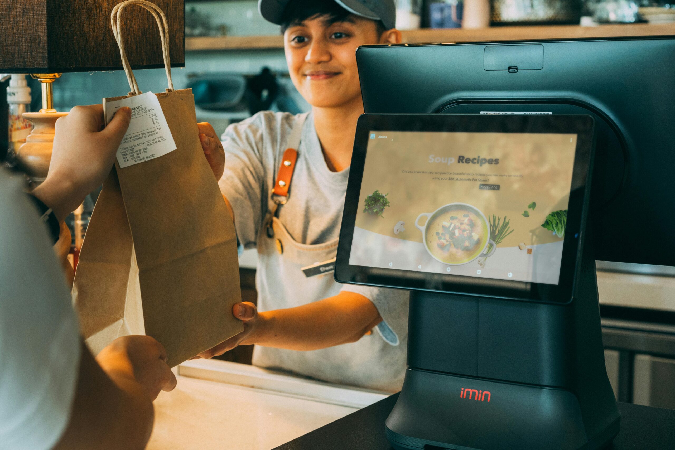 Sales person handing someone a package they just purchased.