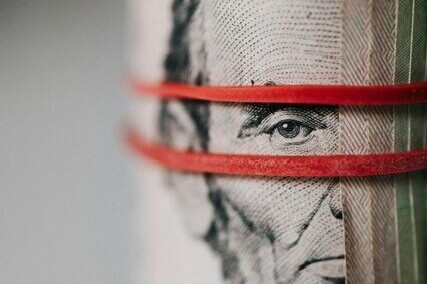 Elastics around a roll of US dollar bills