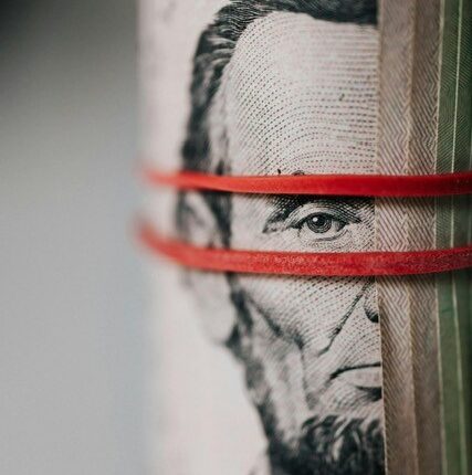 Elastics around a roll of US dollar bills