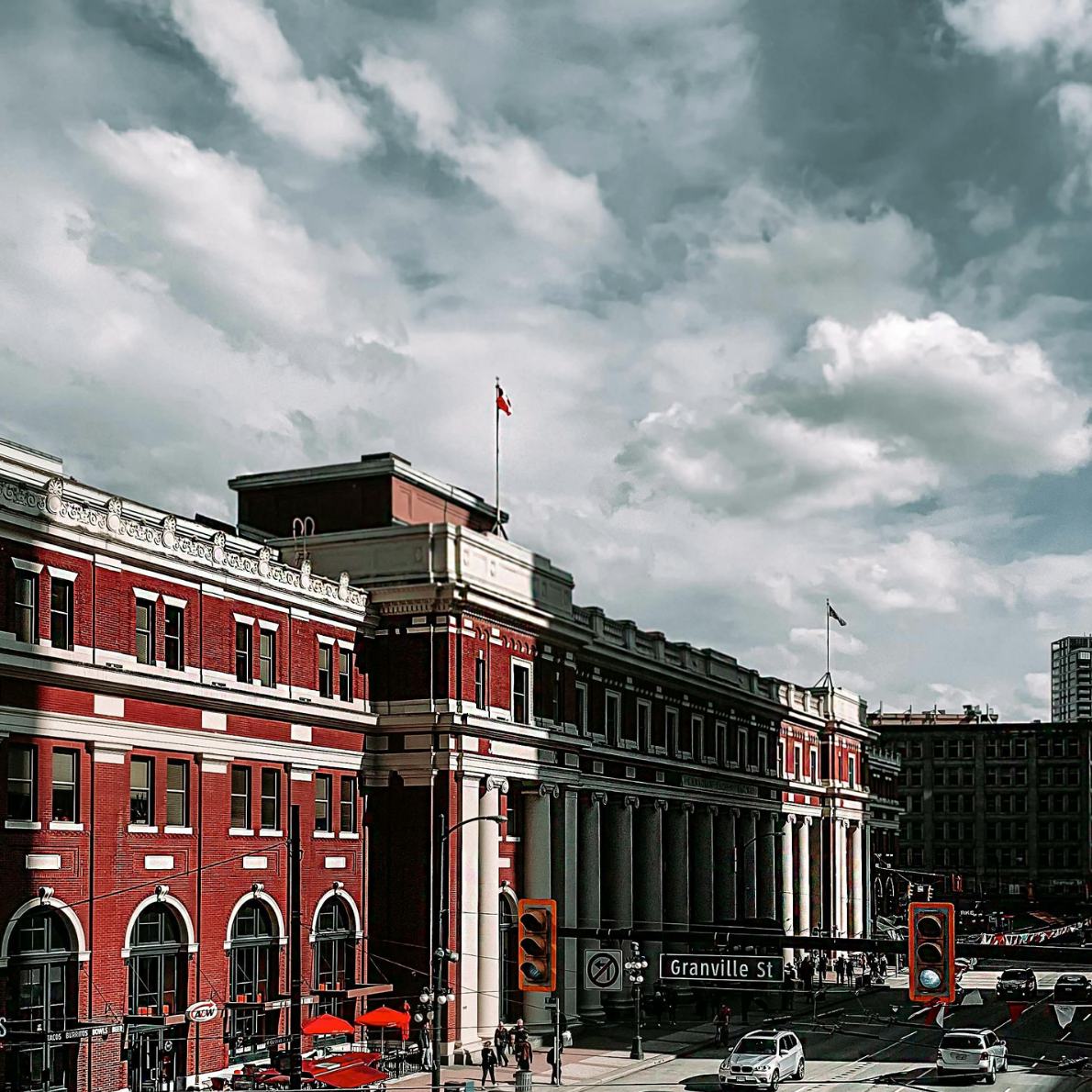 Red and white brick building in downtown Vancouver with Canadian flag