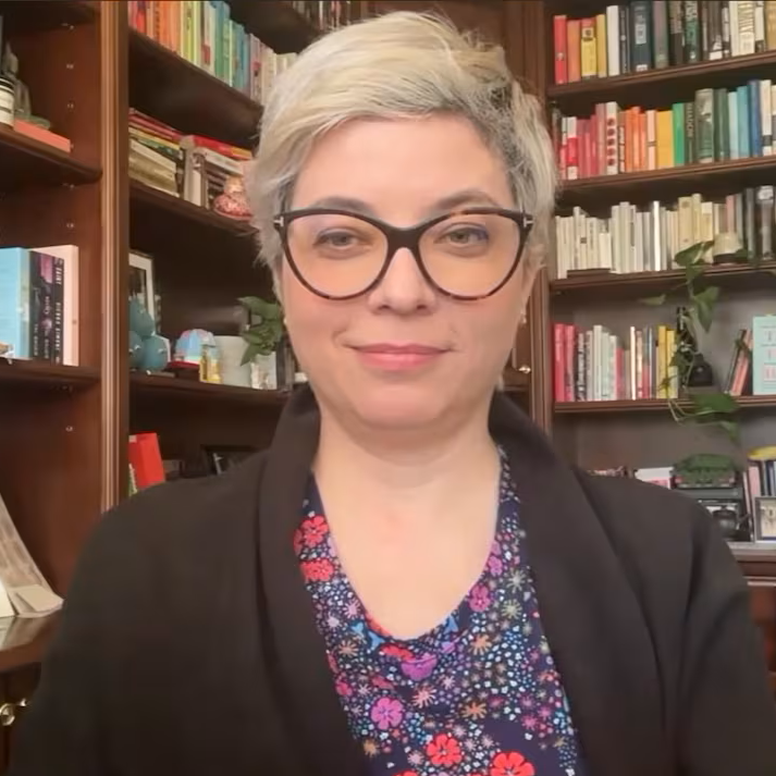 Head shot Claire Trottier in front of bookcase