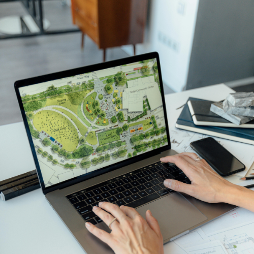map showing on open laptop computer with hands typing