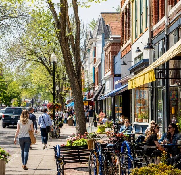 Main street with shops, patios and pedestrians